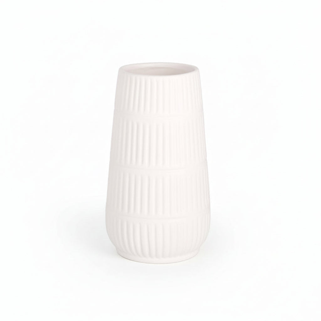 A matte white ceramic round cylinder vase with debossed banded line column design and a tapered bottom base.