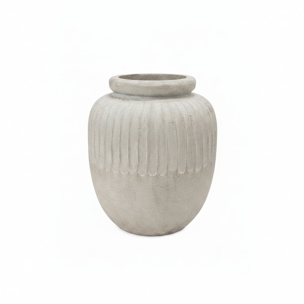 A light gray concrete planter pot with a ribbed vertical texture and a flared rim, shown on a solid white background.