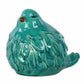 A glossy teal porcelain bird figurine with a matte beak and feet.