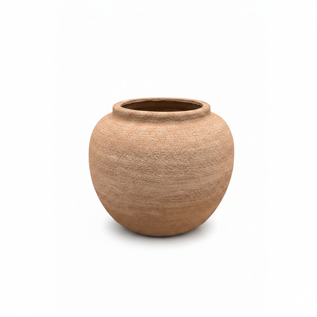 A round, open-top clay pot with a textured, earthy brown surface, centered on a plain white background.