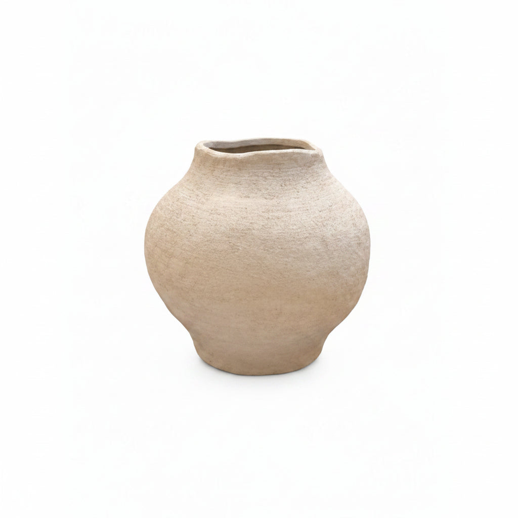 A small, rounded ceramic vase with a wide, shallow opening, featuring a textured, speckled beige glaze on a solid white background.