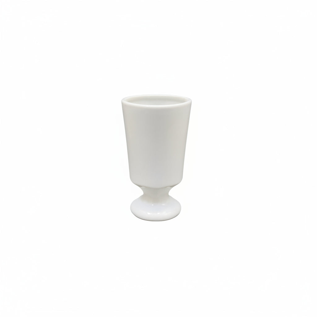 A white ceramic goblet or tumbler with a flared base, centered on a plain white background.