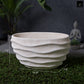 White textured planter with dimensions on a dark background