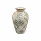A vintage ceramic vase with a cream-colored glaze, decorated with green botanical patterns and a small yellow accent, set against a plain white background.
