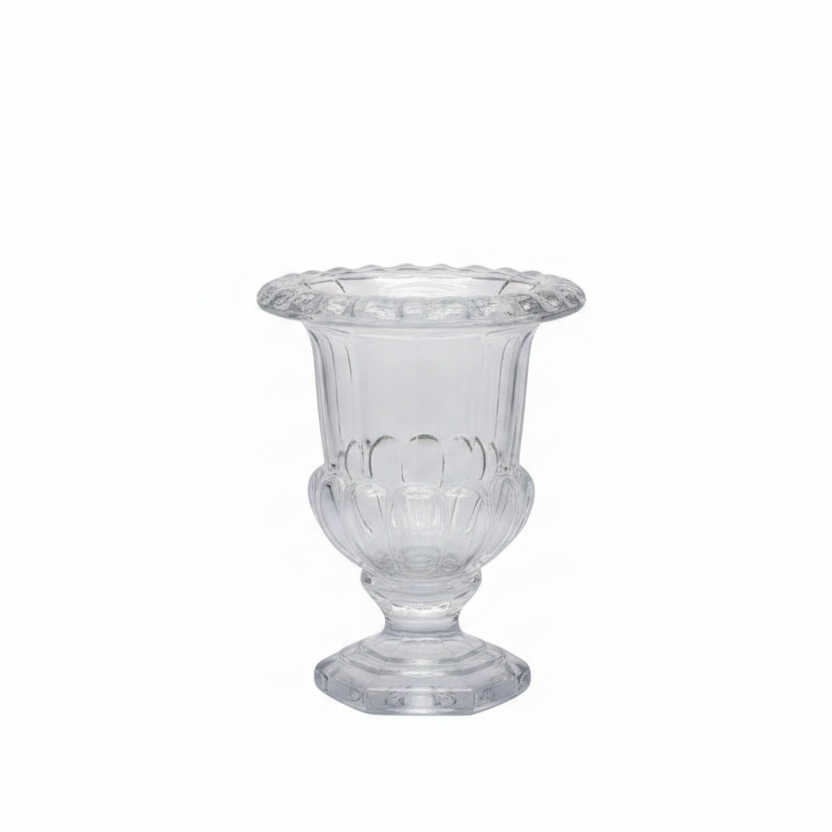 A clear glass pedestal cup or vase with a flared rim and decorative embossed pattern, shown on a plain white background.