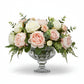 Floral arrangement with pink and white flowers in a glass vase on a white background