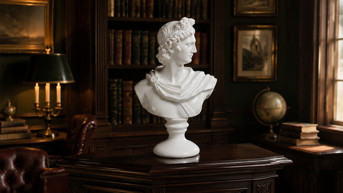 A white classical-style bust sculpture of Queen Elizabeth II, displayed on a dark wooden desk inside a traditional, dimly lit study with bookshelves, a lamp, and a globe in the background.